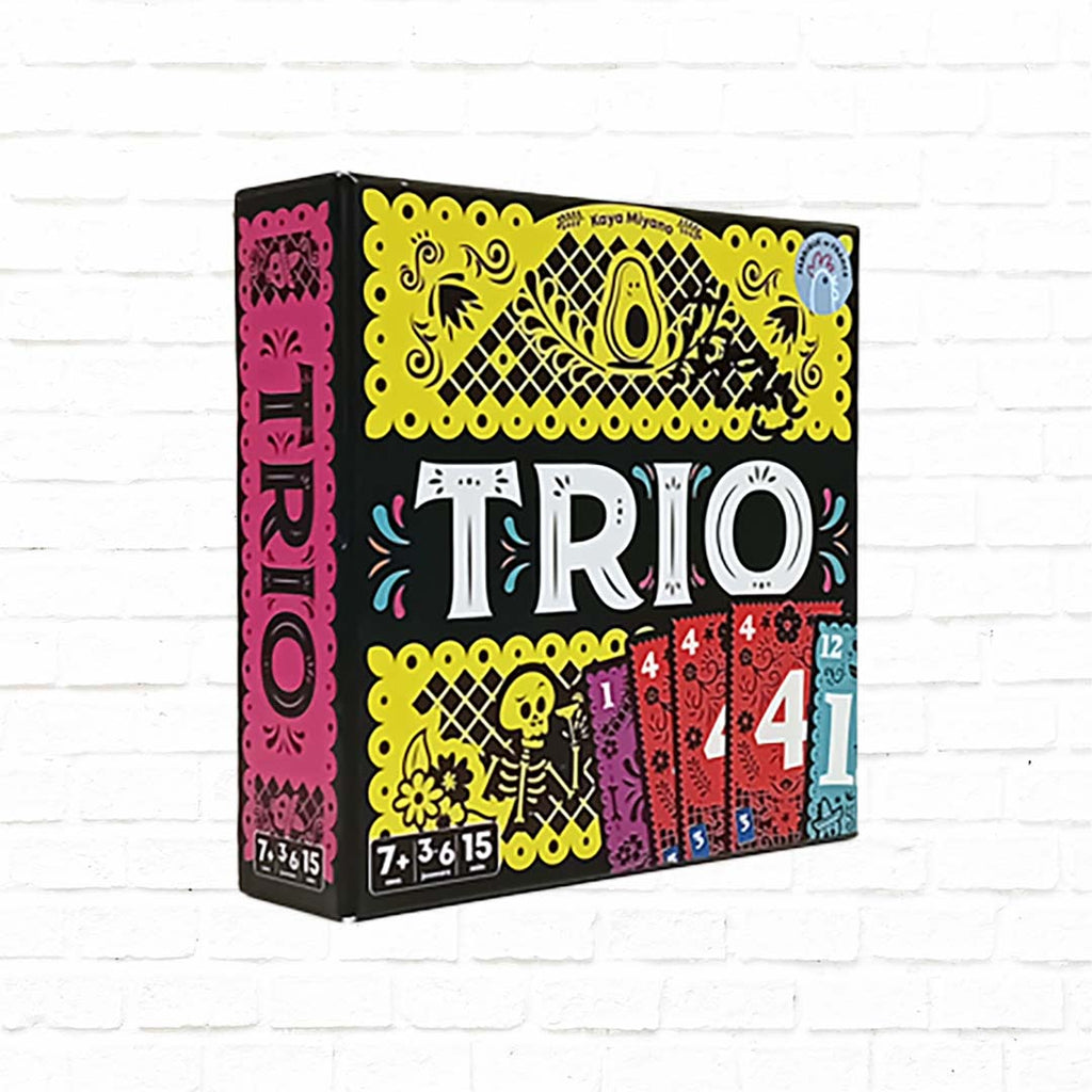 colorful card game for famly and friends, white "TRIO" sign and yellow backdrop