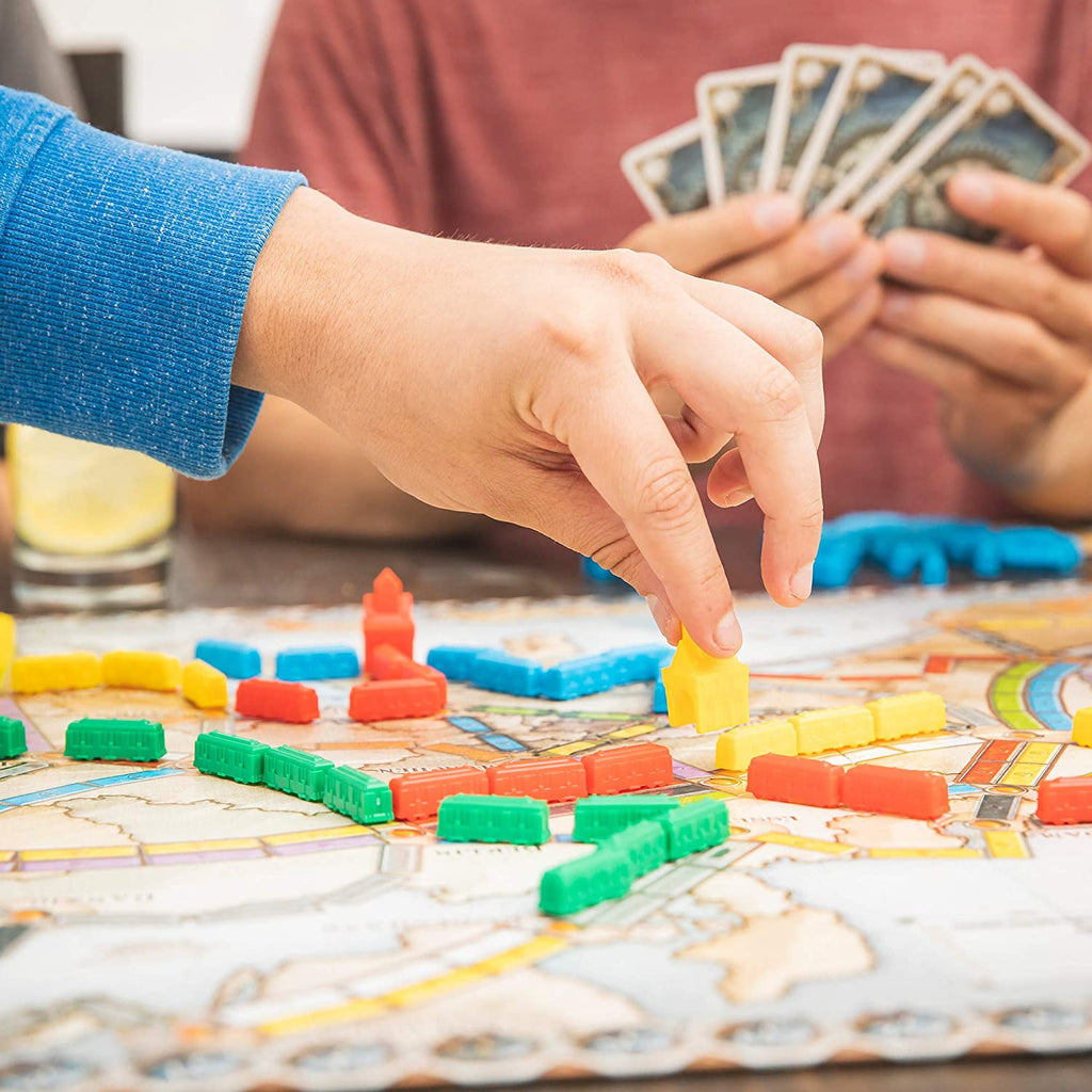 boys playing the ticket to ride board game