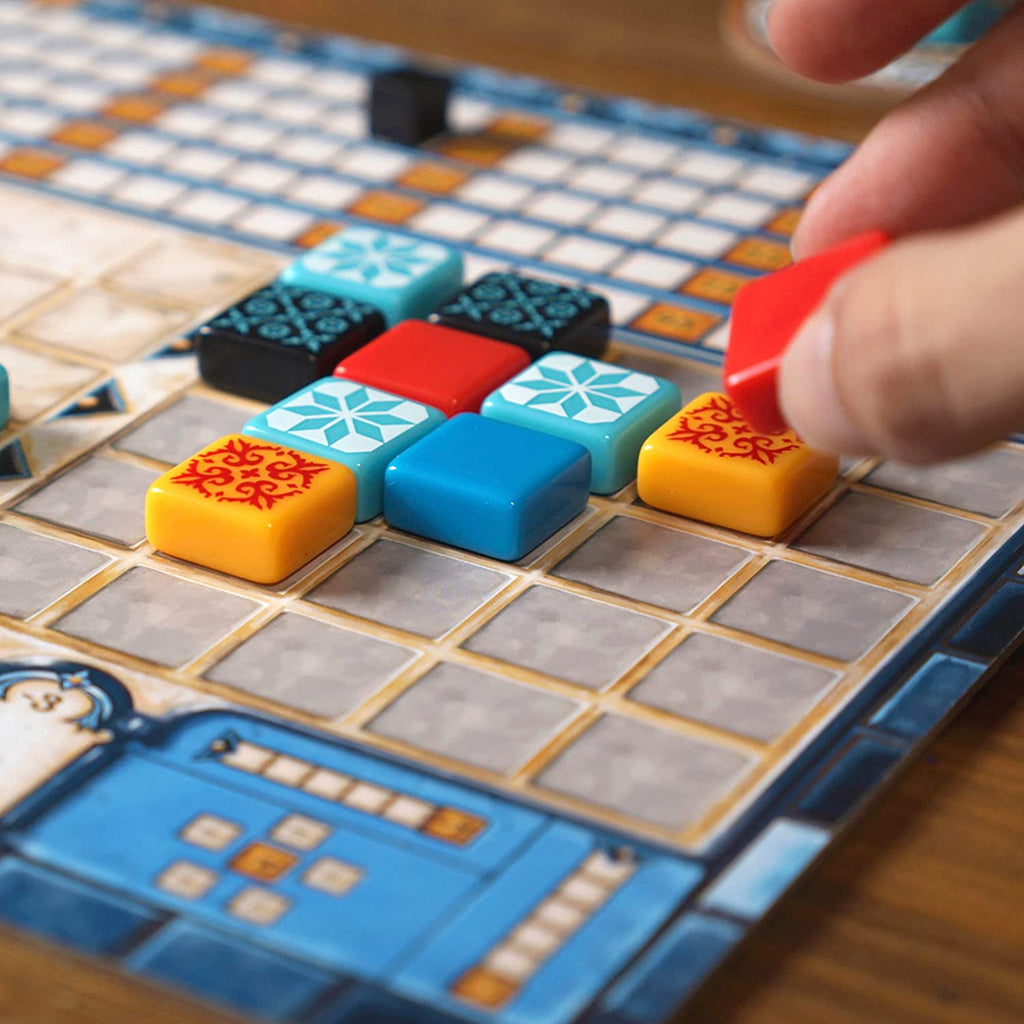 azul board game player placing a red tile on his board
