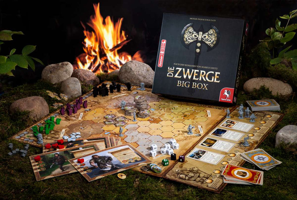Pegasus Spiele The Dwarves board game contents beside a camp fire
