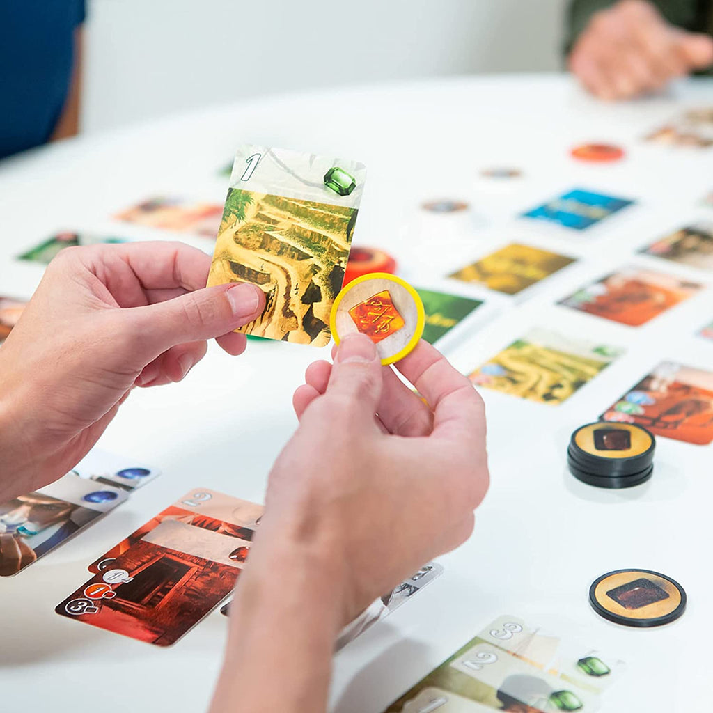 Space Cowboys Splendor board game a man playing a card and a token