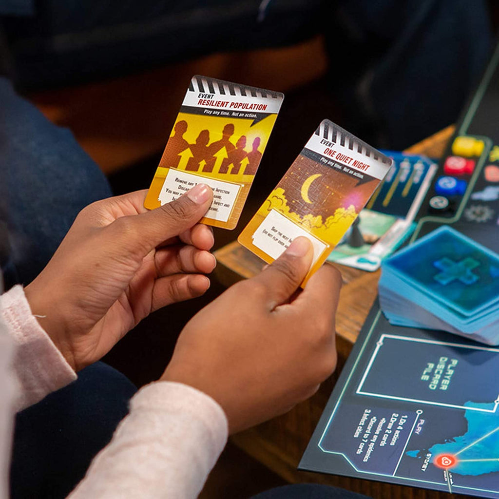 friends playing  cooperative game of pandemic the board game