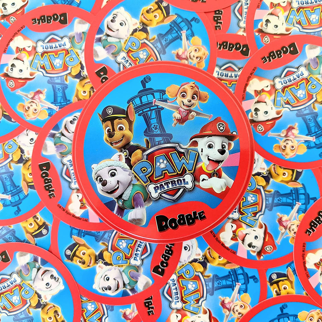 Asmodee Dobble Paw Patrol card game cards spread out on a table