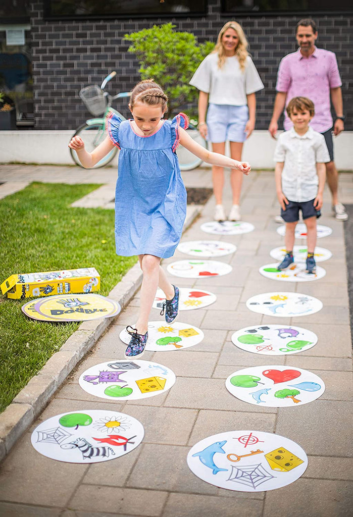 Zygomatic Dobble XXL card game family playing outside in the park