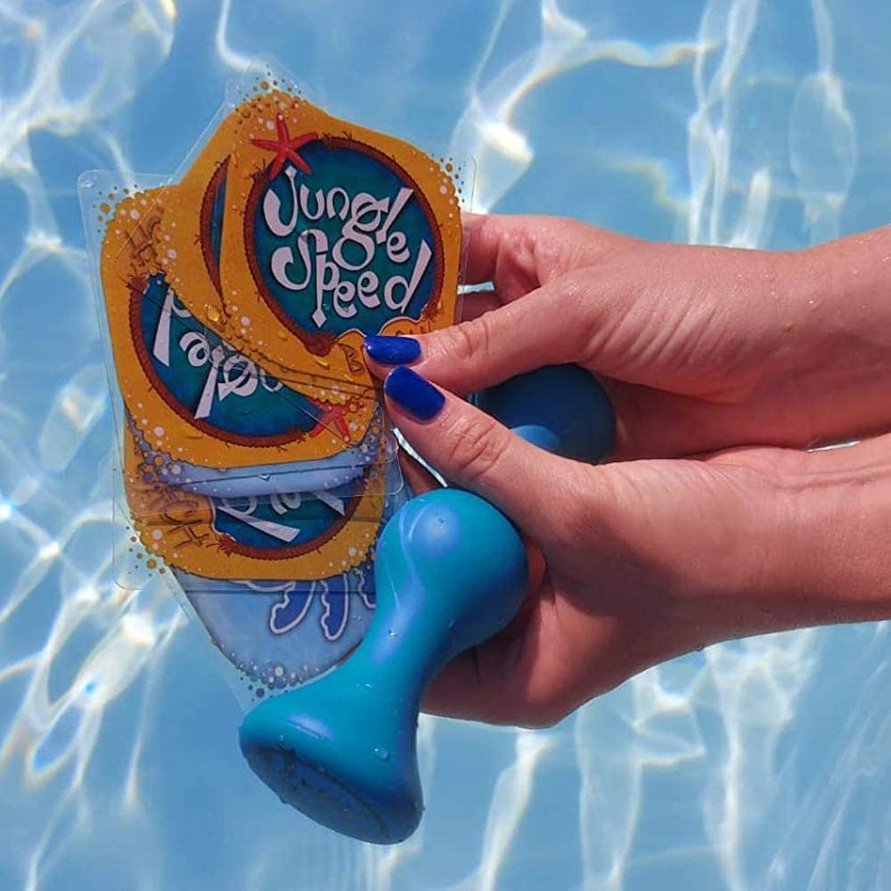 Asmodee Jungle Speed Beach card game a woman holding waterproof cards and a totem displaying them to a camera